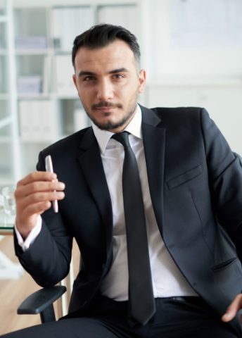 Portrait of handsome Turkish businessman in his office